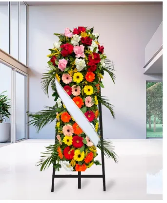 Cuscino funebre verticale su cavalletto con gerbere e rose multicolori