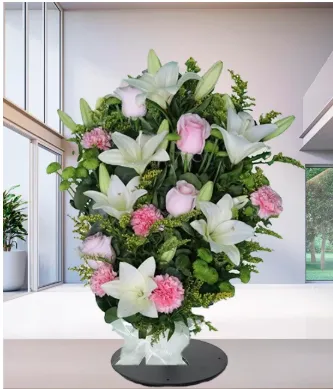 Mazzo funebre di gigli bianchi e rose rosa