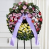 Corona funebre di amarillis anthurium e fiori in armonia