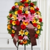 Cuscino funebre di fiori dai toni caldi